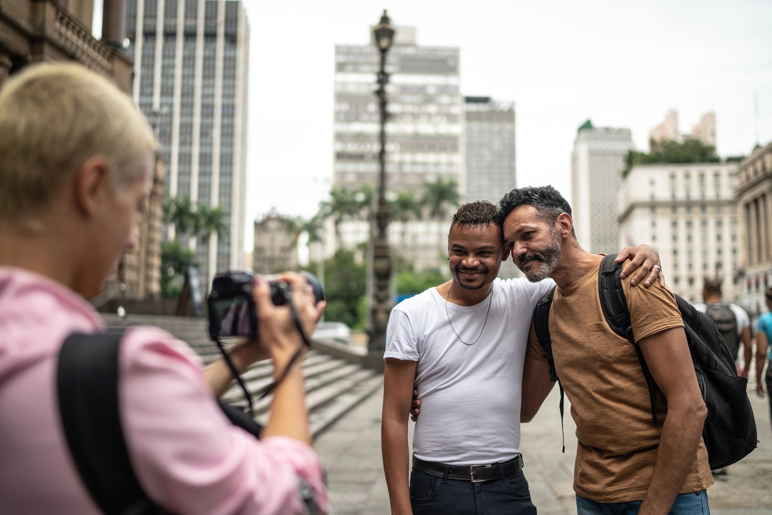 Photographer capturing a couple embracing outdoors