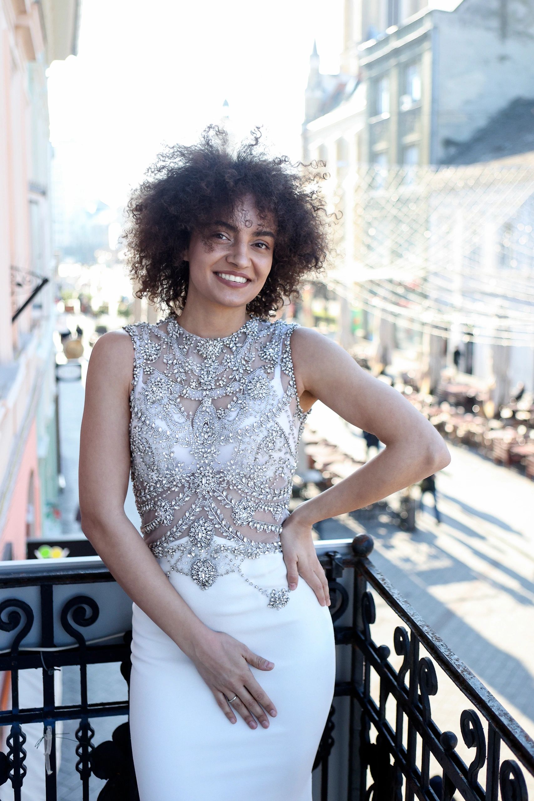 Bride on a balcony in a wedding dress