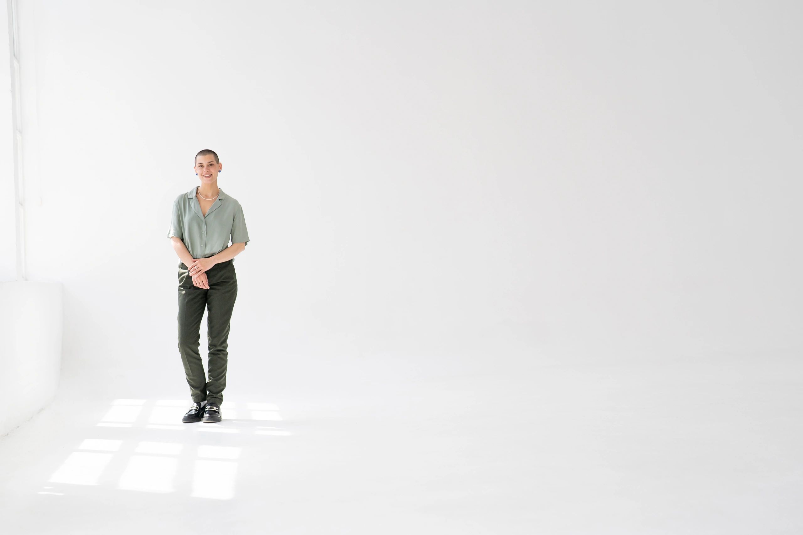 Portrait subject smiling in a bright studio setting
